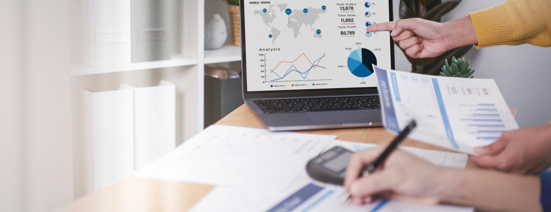 Hand pointing at a visual chart on a computer screen in visible one