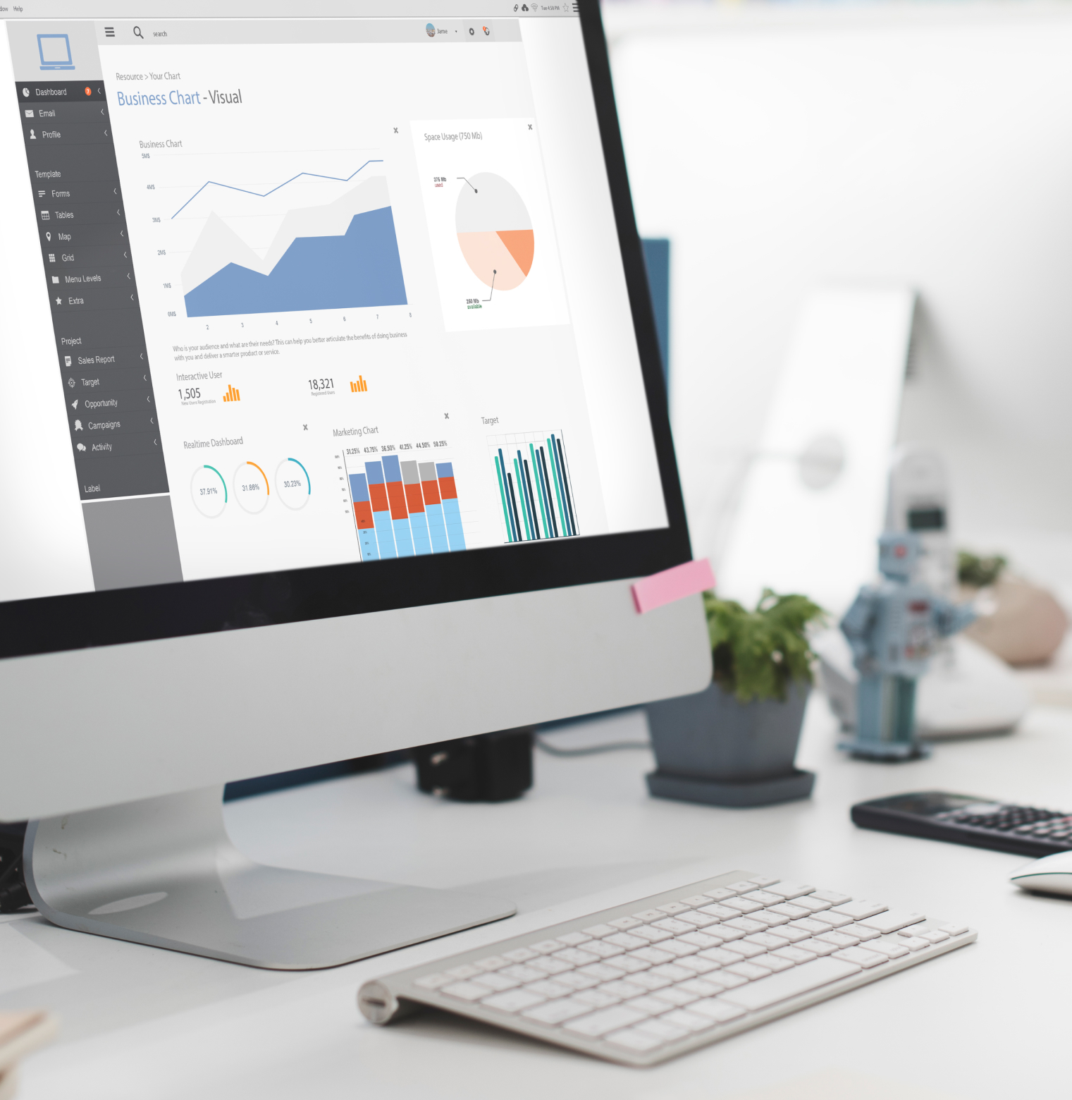 Desktop monitor displaying a data analytics dashboard with various charts and graphs on a clean office desk0