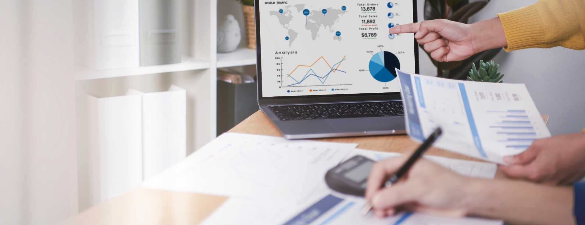 Hand pointing at a visual chart on a computer screen in visible one